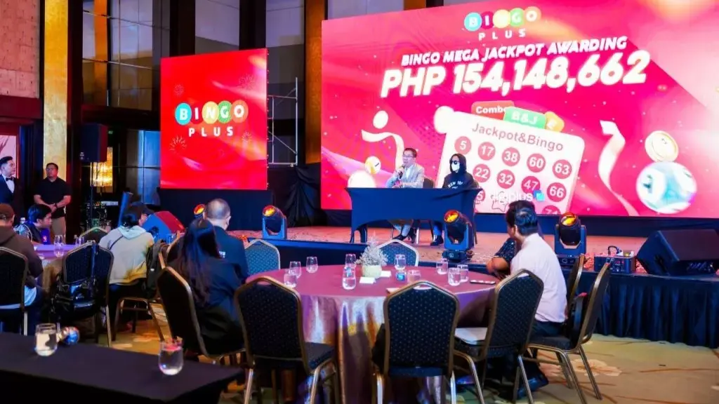 Jackpot winner speaking at a press conference, offering advice to fellow players on responsible gaming.