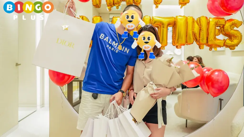 BingoPlus VIP takes a photo with his partner holding a gift