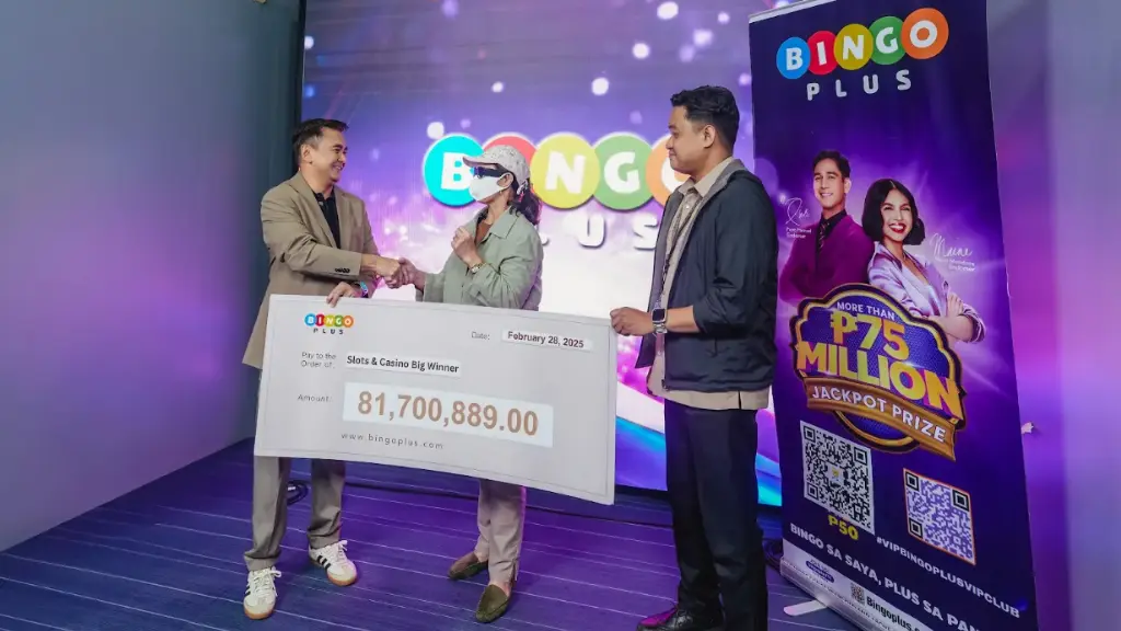 Mr. Jasper Vicencio, president of AB Leisure Exponent Inc., congratulating the Slots & Casino jackpot winner.