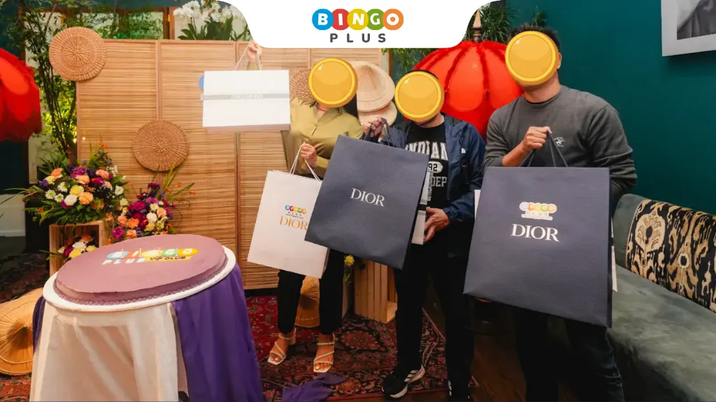 Birthday celebrants for the month of July holding their branded gifts from BingoPlus.