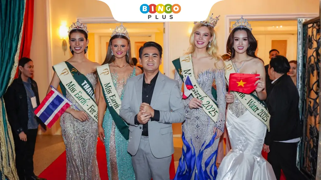 Jasper Vicencio posing with Miss Earth on the red carpet at a glamorous event