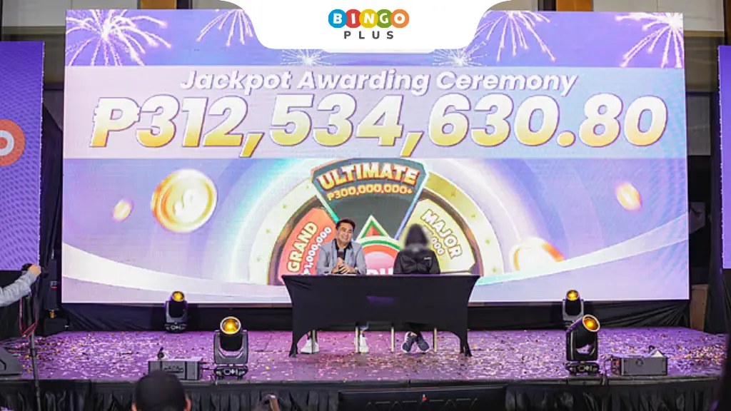 ₱312 Million BingoPlus jackpot winners delivering speeches on stage at the prize awarding event